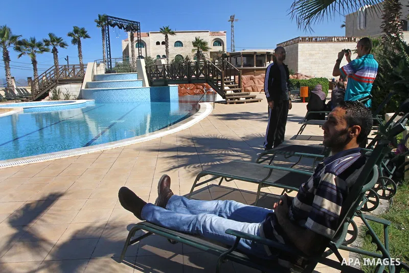 A freed Palestinian prisoner sits near a swimming pool at Al-Mashtal hotel, where he and other former prisoners are currently staying, in the Gaza Strip Oct. 20, 2011. Israeli soldier Gilad Shalit and hundreds of Palesti...