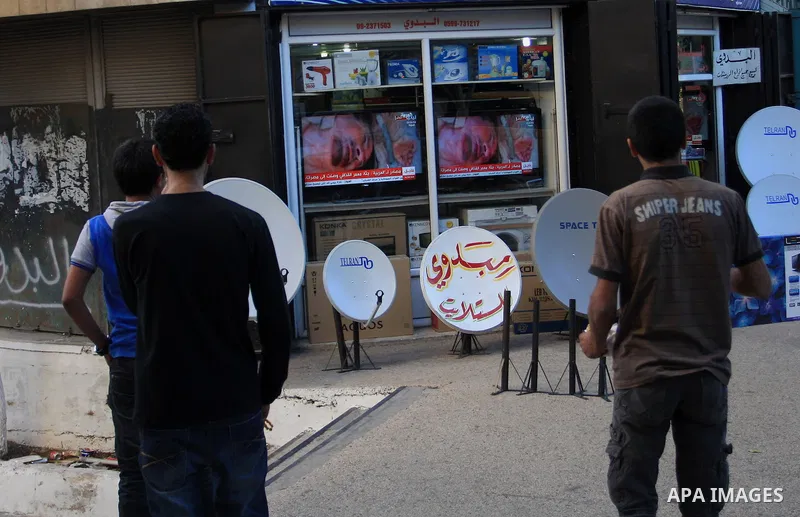 Palestinians watch television news the killing of the Libyan leader,in West Bank, City of Nablus. on October 20, 2011. Head of the military in the city of Tripoli, "Abdel Hakim Belhadj, " the killing of Libyan leader ous...