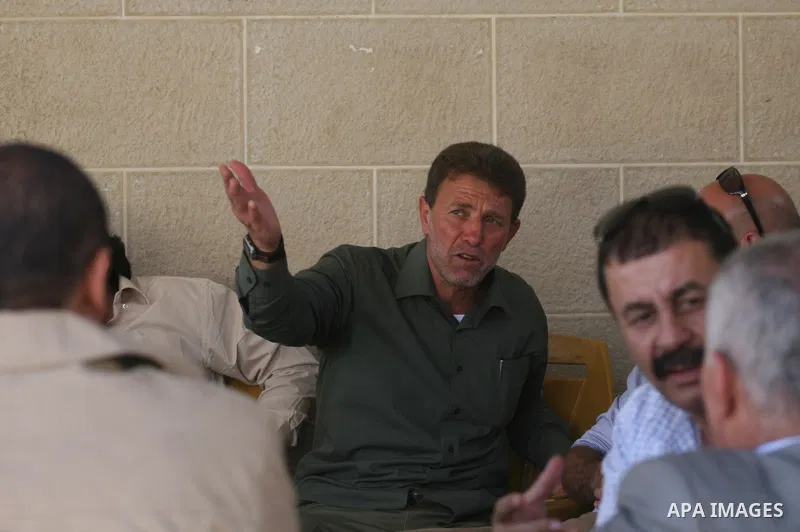 Freed Palestinian prisoner Nael Barghoutia, 53,who served 33 years in jail, more time than any other Palestinian released in a trade for Israeli soldier Gilad Shalit, greets a child along with Fakhri Barghoutia 54 years,...