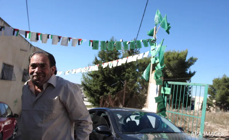 Freed Palestinian prisoner Fakhri Barghoutia, 53,who served 33 years in jail, more time than any other Palestinian released in a trade for Israeli soldier Gilad Shalit, greets a child along with Nael Barghoutia 54 years,...