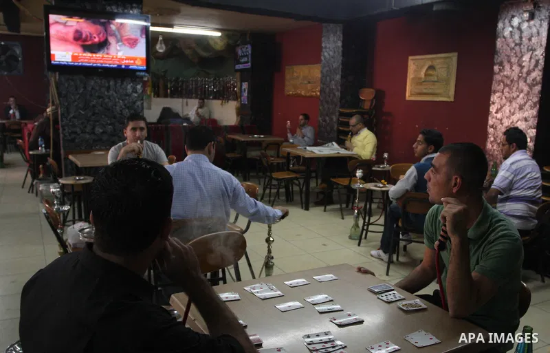 Palestinians watch television news the killing of the Libyan leader,in West Bank, City of Ramallah, on October 20, 2011. Head of the military in the city of Tripoli, "Abdel Hakim Belhadj, " the killing of Libyan leader o...