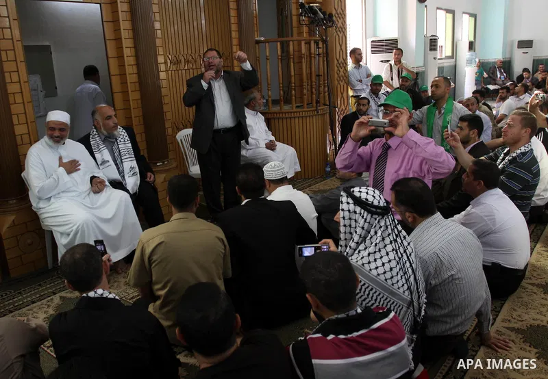 Freed Palestinian prisoners attend Friday prayer with Hamas leader Ismail Haniya in Gaza City on October 21, 2011. Hamas rulers are enjoying a surge in popularity following the release earlier this week of 477 Palestinia...