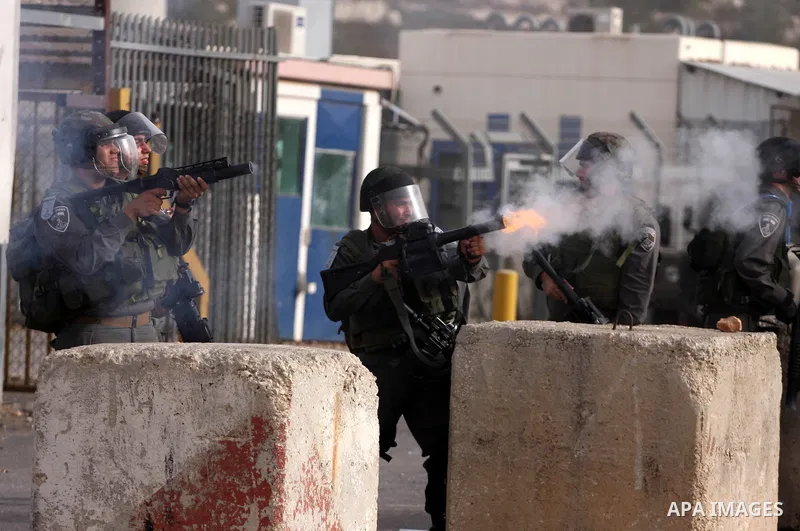Israeli security forces fire teargas at Palestinians during clashes outside Israeli military prison Ofer near the West Bank city of Ramallah. Friday, Oct. 21, 2011. Photo by Issam Rimawi