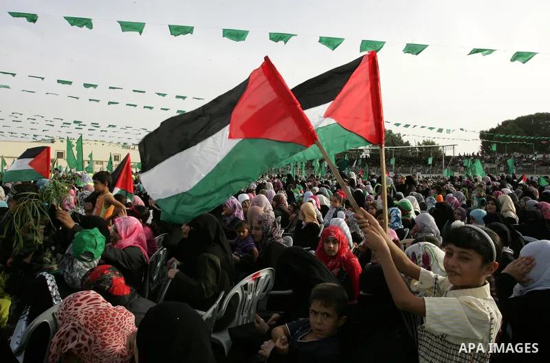 Palestinian supporters of the Islamic group Hamas celebrate the release of hundreds of prisoners following a swap with captured Israeli soldier Gilad Shalit on October 21, 2011 in Khan Yunis, southern Gaza Strip. Hamas r...
