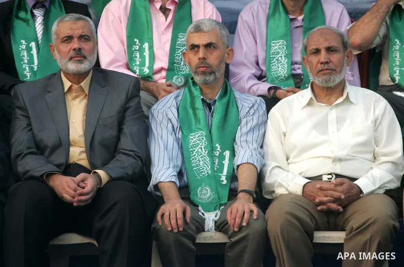Freed Palestinian prisoner Yehiye Sinwar, a founder of Hamas' military wing, sits between Hamas leaders Ismail Haniya and Mahmoud al-Zahar as supporters celebrate the release of hundreds of prisoners following a swap wit...