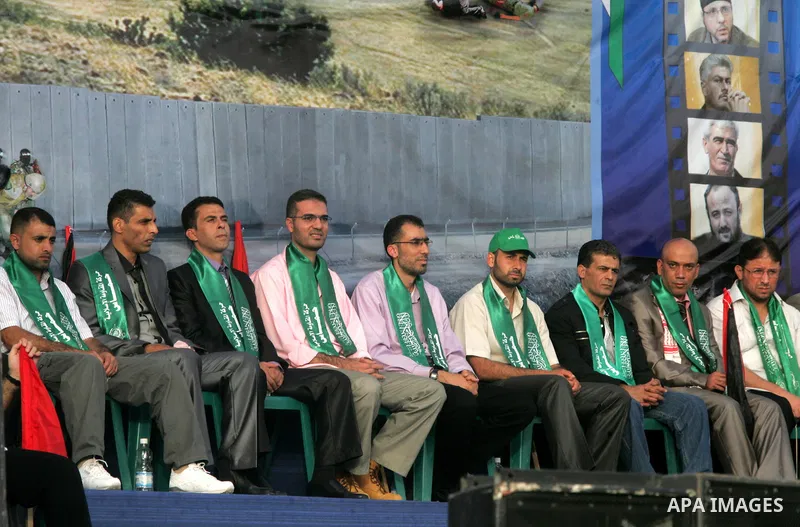 Freed Palestinian prisoners attend a rally as Hamas supporters celebrate the release of hundreds of prisoners following a swap with captured Israeli soldier Gilad Shalit on October 21, 2011 in Khan Yunis, southern Gaza S...