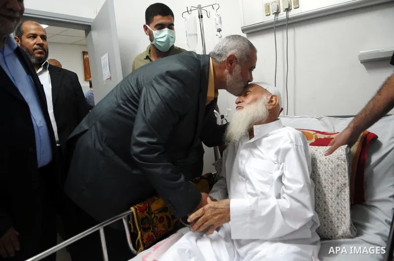 Palestinian Prime Minister in Gaza, Ismail Haniyeh during his visit to the father of the leader Abu Mohammed al-Najjar in the hospital to check on his health. Photo by Ahmed Shaat