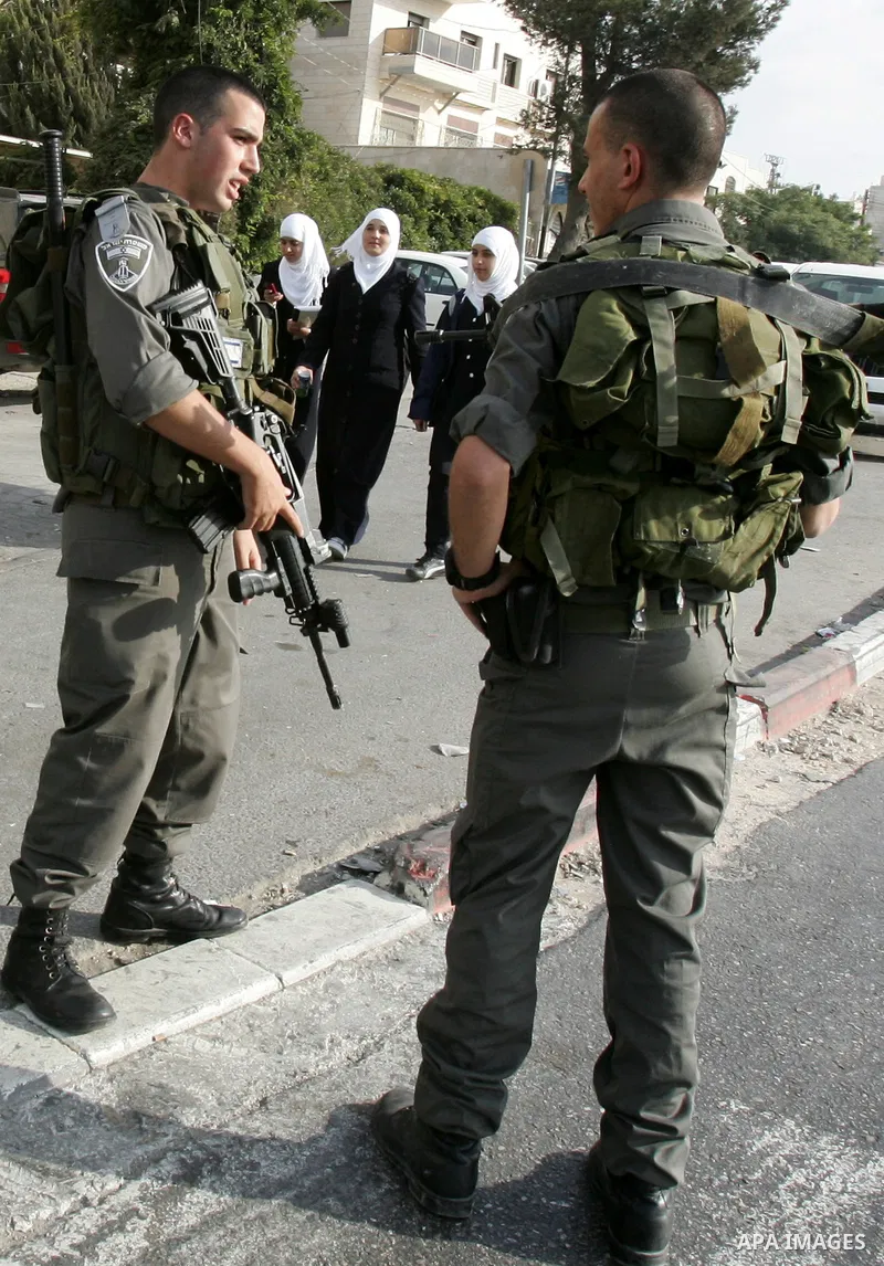 Israeli police officers stand guard during a raid on Al-Quds Development Association headquarters in Beit Hanina on Oct. 23,2011. Israeli forces stormed the association, destroyed some of its contents and confiscated com...