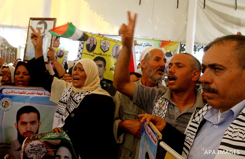 Palestinians gather during a protest at the Red Cross' offices in Gaza City to call for the release of Palestinian prisoners held in Israeli jails, on Oct. 24, 2011. Under a prisoner swap deal signed with Israel, the Isl...