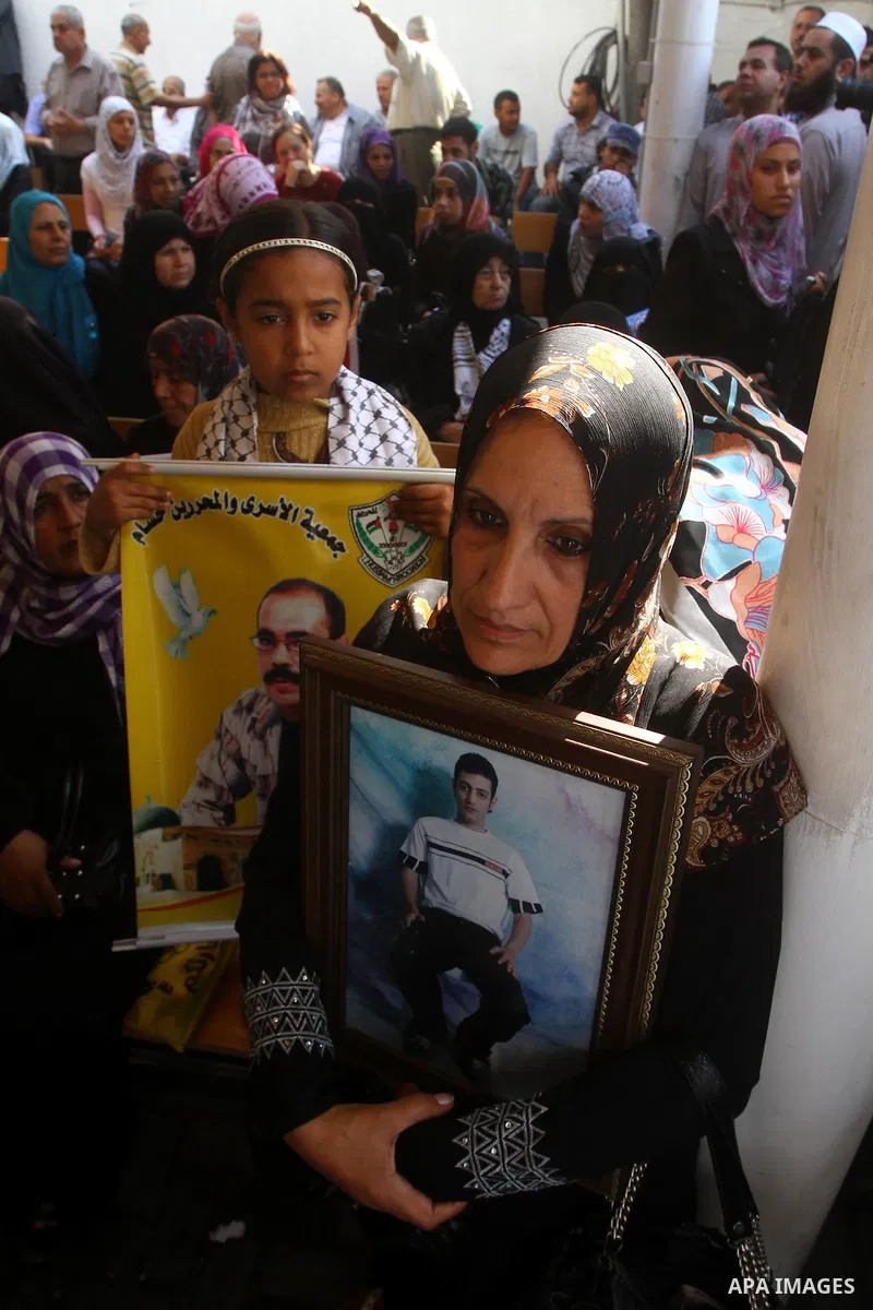 Palestinians gather during a protest at the Red Cross' offices in Gaza City to call for the release of Palestinian prisoners held in Israeli jails, on Oct. 24, 2011. Under a prisoner swap deal signed with Israel, the Isl...