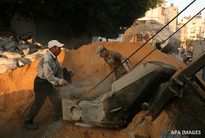 Palestinian labourers work in a residential construction site in Gaza city on Oct. 24,2011 as Palestinians in Gaza Strip suffer from lack of construction materials since the Israeli blockade so they use the tunnels under...