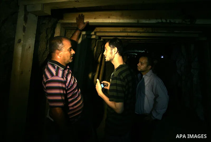 Freed Palestinian prisoners and their relatives walk through a tunnel underground the border between Egypt and southern Gaza Strip town of Rafah on Oct. 26,2011. Prisoners released to the Gaza Strip in a dramatic swap fo...