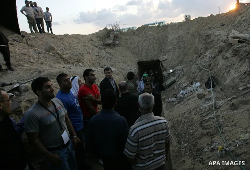 Freed Palestinian prisoners and their relatives walk through a tunnel underground the border between Egypt and southern Gaza Strip town of Rafah on Oct. 26,2011. Prisoners released to the Gaza Strip in a dramatic swap fo...