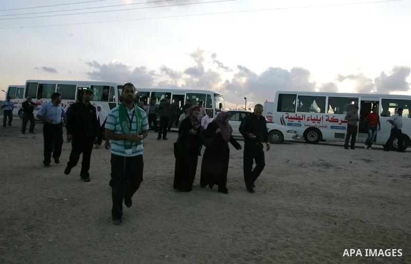 Freed Palestinian prisoners and their relatives walk toward a tunnel underground the border between Egypt and southern Gaza Strip town of Rafah on Oct. 26,2011. Prisoners released to the Gaza Strip in a dramatic swap for...
