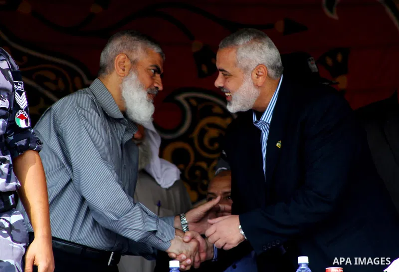 Palestinian prime minister in Gaza Strip, Ismail Haniya shakes hands with freed prisoner Rawhe Mushtaha during a ceremony organised by Hamas police in Gaza City in front of the media and Palestinian prisoners released in...