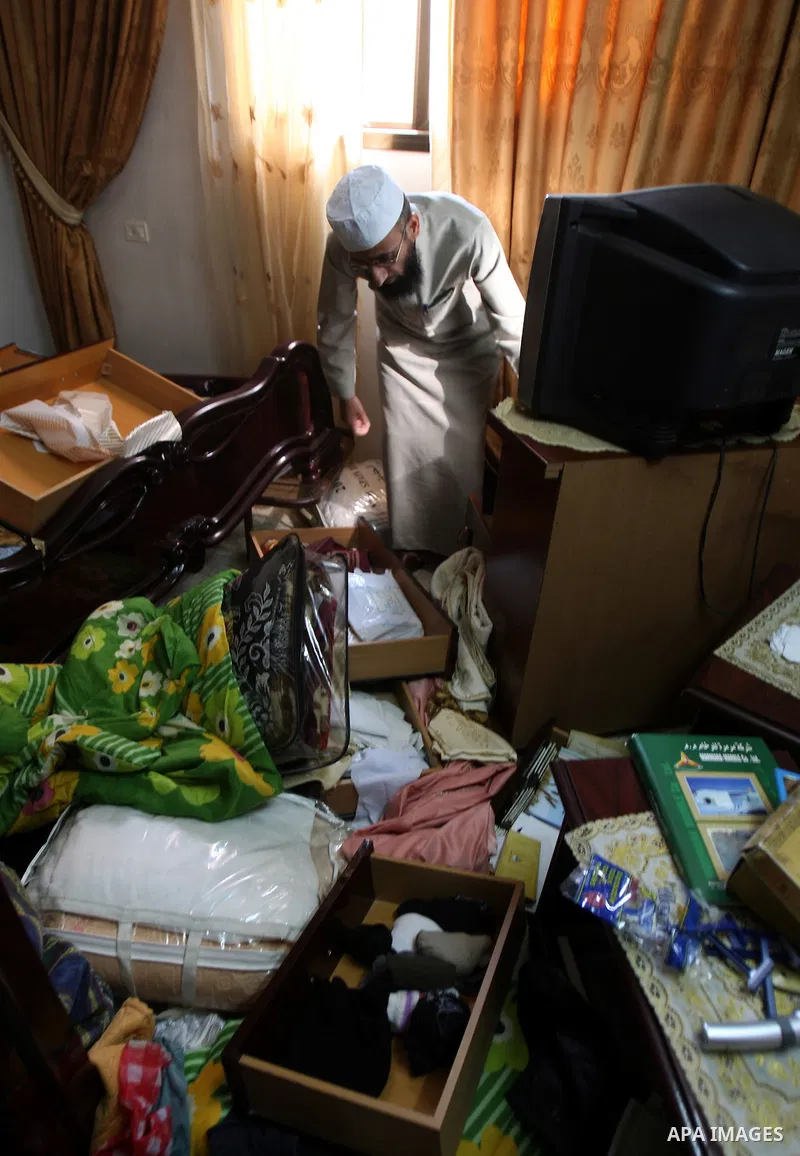 Palestinians inspect a damage room of their home in the Balata Refugee Camp in the West Bank City of Nablus, on 27 October 2011. Homes at the camp were apparently damaged during an Israeli military raid on a manhunt for...