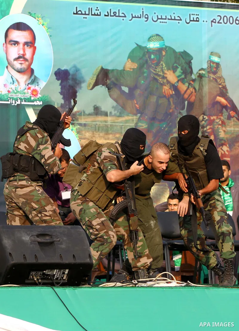 Hamas militants take part in a celebration of the recent release of hundreds of Palestinians by Israel in the central Gaza Strip, Friday, Oct. 28, 2011. Hundreds of Palestinians were released in exchange for captured Isr...