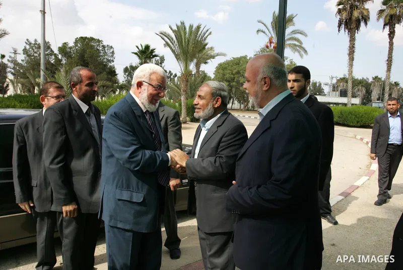 Jumaa Amen, deputy leader of the Muslim Brotherhood in Egypt (L) chek Hands With Hamas leader Mahmud El-Zahar(R) in Rafah crossing, southern Gaza Strip, Saturday, Oct. 29, 2011. Photo by Abed Rahim Khatib