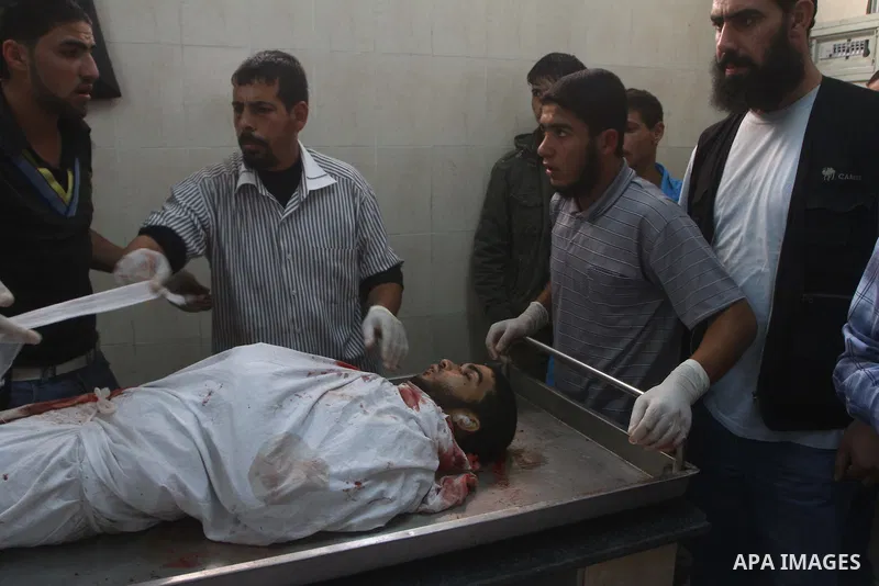 Palestinians surround the body of a militant, killed in an Israeli air strike, at a hospital morgue in Rafah in the southern Gaza Strip October 29, 2011. Israeli forces attacked an Islamic Jihad camp in the southern Gaza...