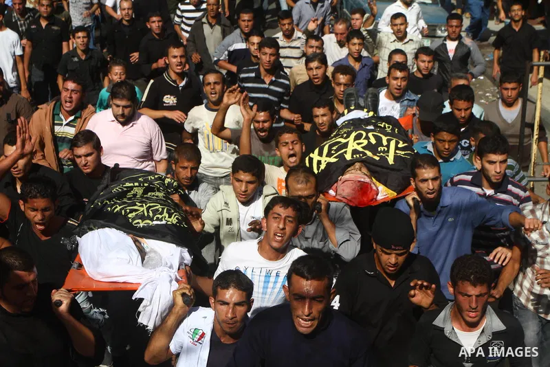 Palestinian mourners take part in the funerals of militants of the Islamic Jihad movement in Gaza City on Oct. 30, 2011, killed during Israeli air raids late last night. The Islamic Jihad said it would observe an Egyptia...