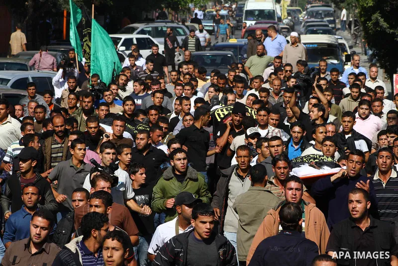 Palestinian mourners take part in the funerals of militants of the Islamic Jihad movement in Gaza City on Oct. 30, 2011, killed during Israeli air raids late last night. The Islamic Jihad said it would observe an Egyptia...