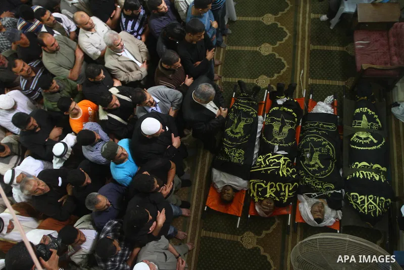 Palestinian mourners pray over the bodies of Islamic Jihad militants, who were killed in Israeli air strikes, during their funeral at a mosque in Gaza City, on Oct. 30, 2011. Islamic Jihad movement said Sunday that it ac...