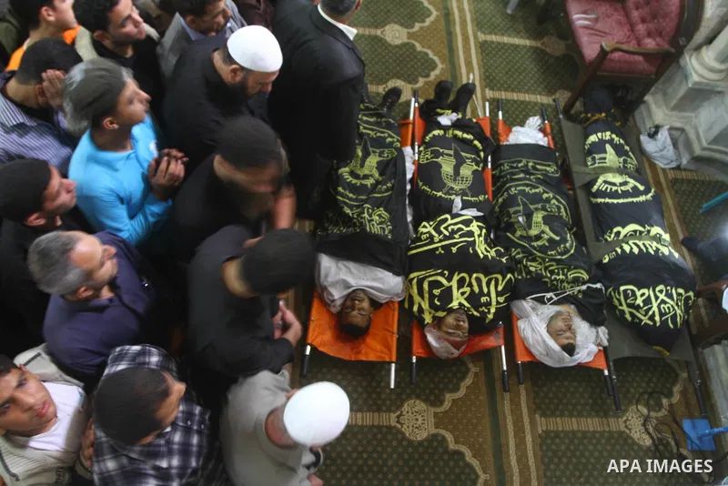 Palestinian mourners pray over the bodies of Islamic Jihad militants, who were killed in Israeli air strikes, during their funeral at a mosque in Gaza City, on Oct. 30, 2011. Islamic Jihad movement said Sunday that it ac...