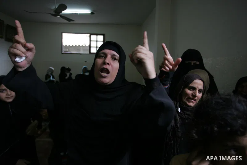 Relatives of Palestinian commander Ahmed al-Sheikh Khalil of the Islamic Jihad movement mourn during his funeral at Rafah town in the southern Gaza Strip on October 30, 2011, killed during Israeli air raids late last nig...