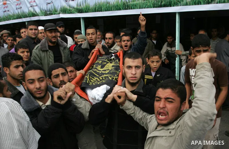 Palestinians carry the body of local Islamic Jihad militant leader Ahmed Sheikh Khalil and two other militants during their funeral in Rafah, southern Gaza Strip, Sunday, Oct. 30, 2011. Nine militants and an Israeli civi...