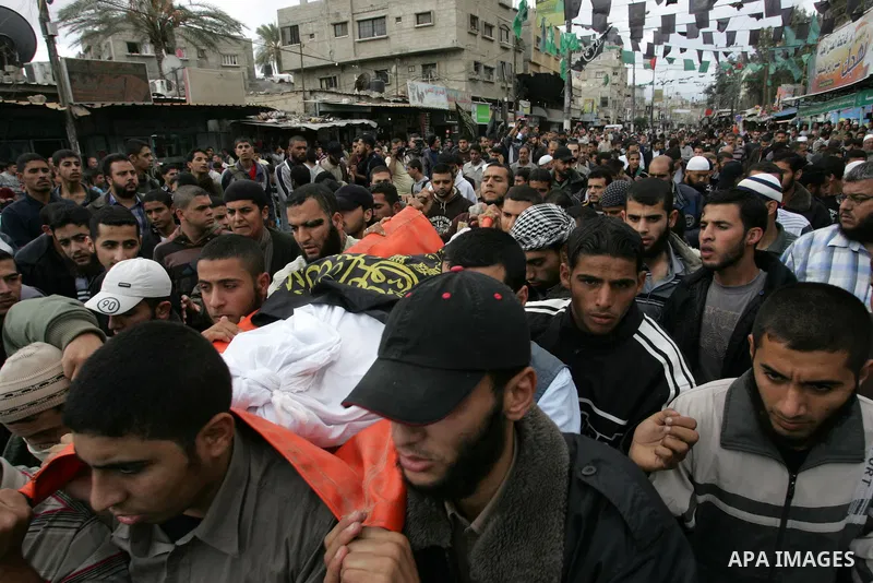 Palestinians carry the body of local Islamic Jihad militant leader Ahmed Sheikh Khalil and two other militants during their funeral in Rafah, southern Gaza Strip, Sunday, Oct. 30, 2011. Nine militants and an Israeli civi...