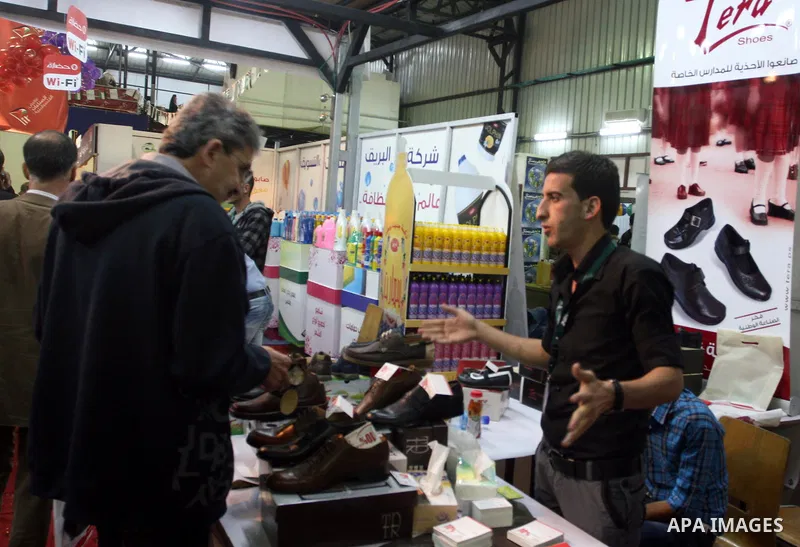 Palestinians tour inside the Palestinian National Industries Exhibition, in the West Bank city of Ramallah on October 30, 2011. Photo by Issam Rimawi