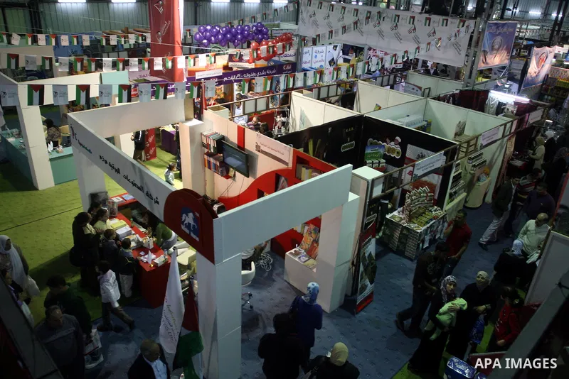 Palestinians tour inside the Palestinian National Industries Exhibition, in the West Bank city of Ramallah on October 30, 2011. Photo by Issam Rimawi