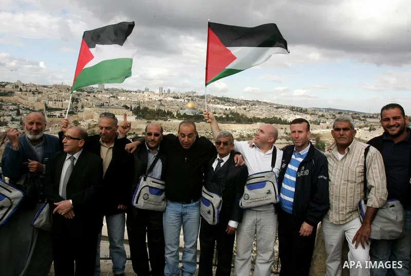 Palestinian pilgrims, who are freed prisoners and their relatives, take pictures before their head to the annual hajj or pilgrimage in the Saudi Muslim holy city of Mecca, in Jerusalem's old city on October 30, 2011. Pho...