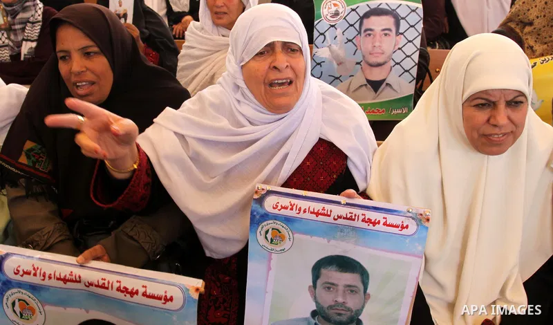 Palestinians gather during a protest at the Red Cross' offices in Gaza City to call for the release of Palestinian prisoners held in Israeli jails, on Oct. 31, 2011. An Egyptian-brokered truce appeared to be taking hold...