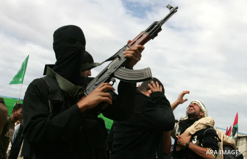 A Palestinian Democratic Front for the Liberation of Palestine militant shoots in the air during the funeral of DFLP militant Ahmed Jargon, killed in an Israeli strike on Sunday, in Rafah, southern Gaza Strip, Monday, Oc...