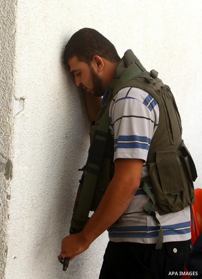 A Palestinian militant from the Democratic Front for the Liberation of Palestine (DFLP) reacts during the funeral of his comrade Ahmed Jargoon, in Rafah, southern Gaza Strip, Monday, Oct. 31, 2011. Deadly violence betwee...