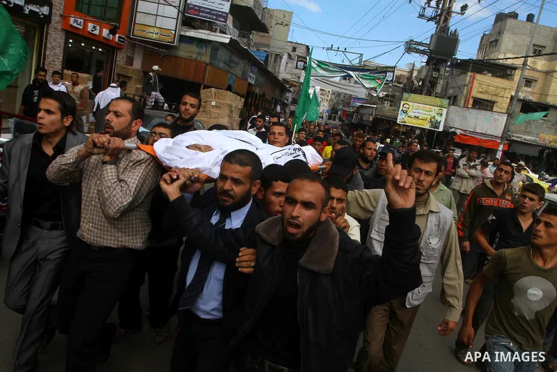 Palestinians mourn the body of Al-Ansar brigade militant Ali Alakad who was killed in an Israeli air strike early Monday, in Khan Younis, southern Gaza Strip, Monday, Oct. 31, 2011. Deadly violence between Israel and Gaz...