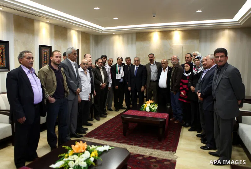 Palestinian Prime Minister Salam Fayyad meets with the freed prisoners at the ministers council headquarters in the West Bank city of Ramallah, on, Oct. 31, 2011. Photo by Mustafa Abu Dayeh