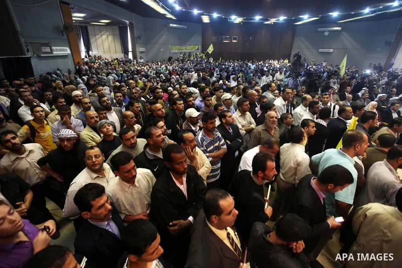 Fatah Movement supporters celebrate the release of hundreds of prisoners following a swap with captured Israeli soldier Gilad Shalit at al-Shawwa theatre, in Gaza city on Nov. 2,2011. Photo by Ashraf Amra