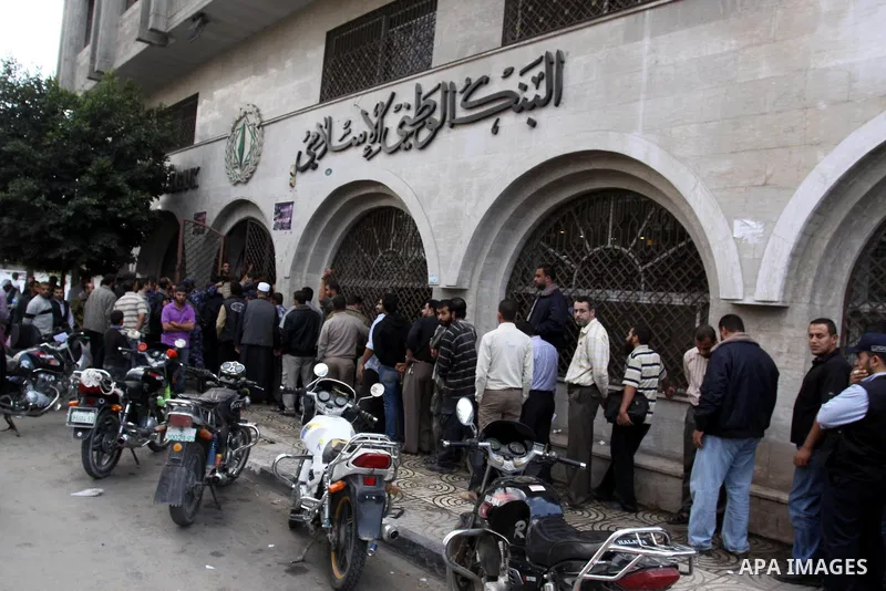 Palestinian Authority civil servants gather outside the Islamic Bank in Gaza city on Nov. 03,2011, to withdraw their monthly salaries. Photo by Mohammed Asad