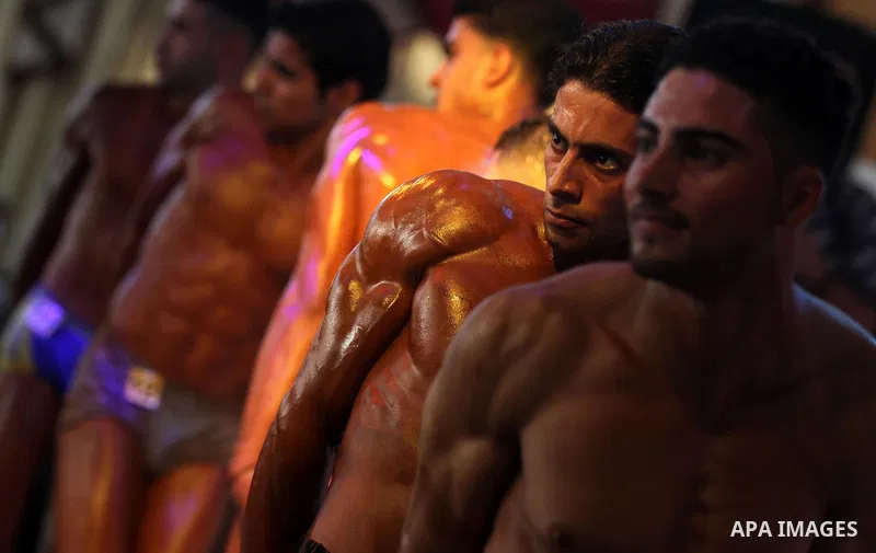 Palestinian men take part during competing in a bodybuilding contest at a hall in Gaza city, Nov. 3, 2011. Many of the men use women's cosmetics, mud, or paint to enhance their muscles. Number of men from around the Gaza...