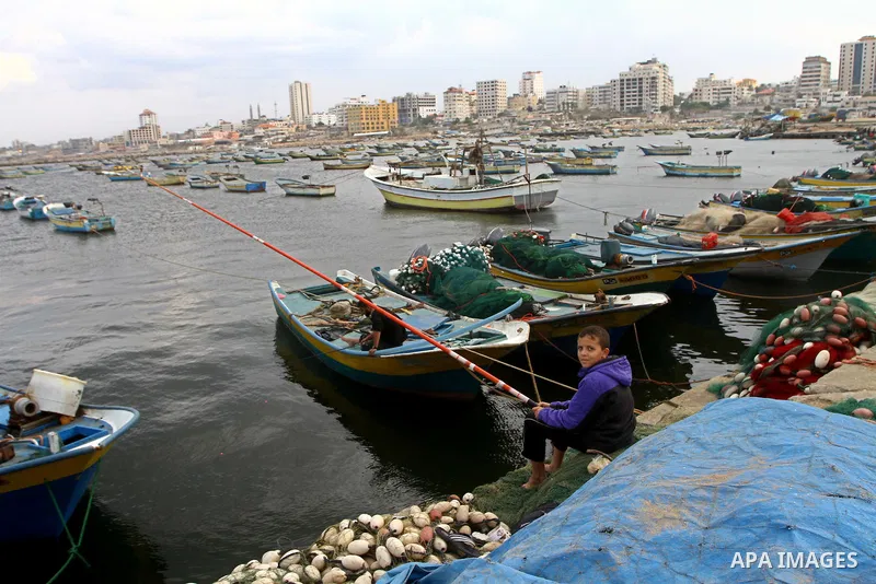 A Palestinian boy fishes at the Gaza Seaport November 4, 2011. The United States warned on Thursday that a new effort by pro-Palestinian activists to send a flotilla to challenge Israel's blockade of the Gaza Strip was d...