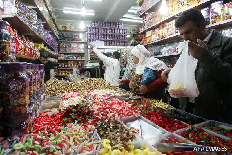 Palestinians shop in front of the Damascus gate in Jerusalem's old city on Nov. 4,2011, ahead of the Muslim Eid al-Adha festival at the end of the week. Muslims across the world are preparing to celebrate the annual "Fes...