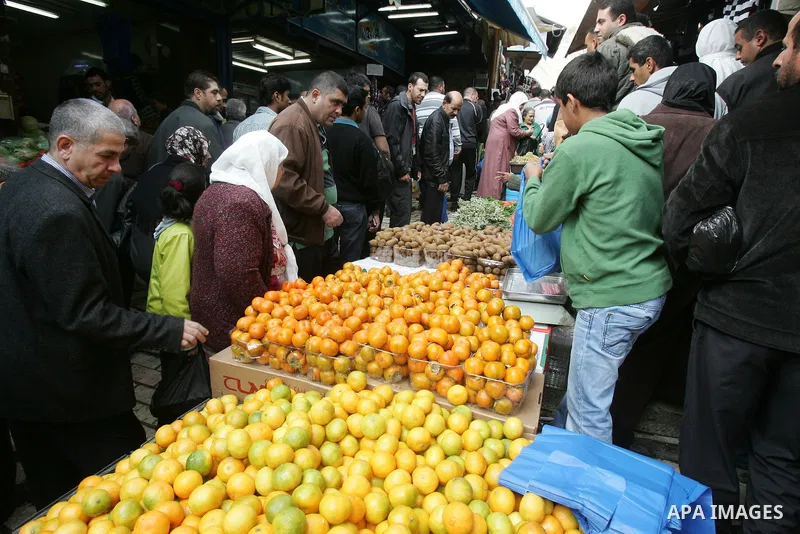 Palestinians shop in front of the Damascus gate in Jerusalem's old city on Nov. 4,2011, ahead of the Muslim Eid al-Adha festival at the end of the week. Muslims across the world are preparing to celebrate the annual "Fes...