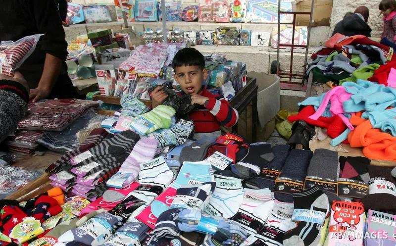 Palestinians shop in front of the Damascus gate in Jerusalem's old city on Nov. 4,2011, ahead of the Muslim Eid al-Adha festival at the end of the week. Muslims across the world are preparing to celebrate the annual "Fes...