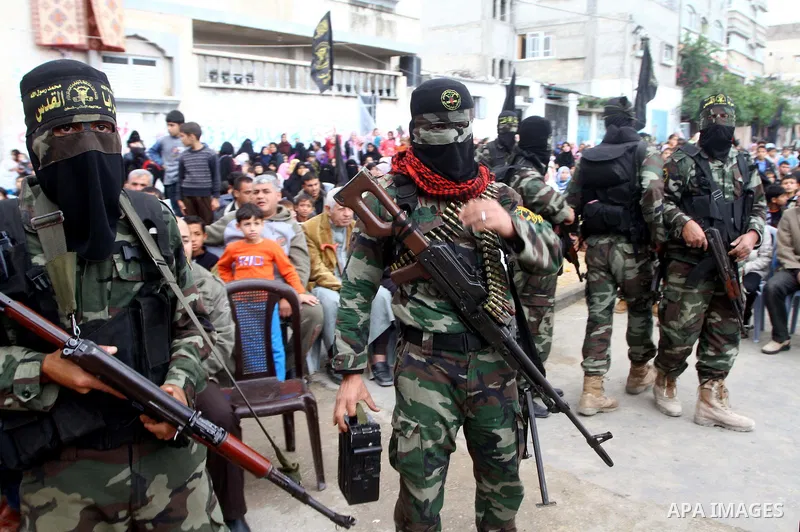 Palestinian Islamic Jihad militants and supporters take part in a rally marking the 16th anniversary of the killing of Fathi al-Shiqaqi, the militant movement's founder, in the northern Gaza Strip November 4, 2011. The m...