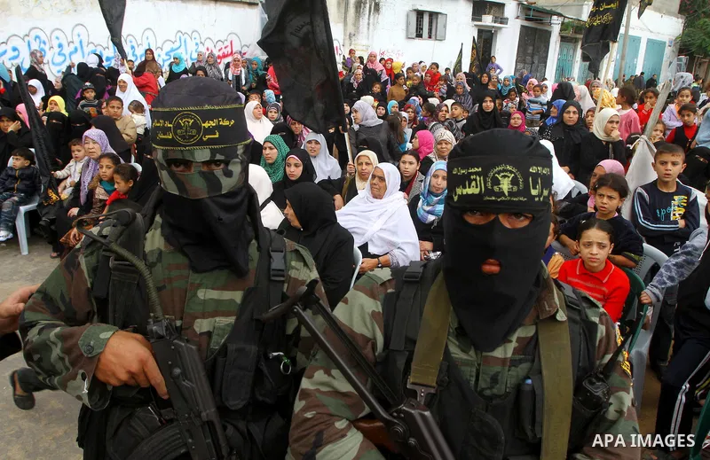 Palestinian Islamic Jihad militants and supporters take part in a rally marking the 16th anniversary of the killing of Fathi al-Shiqaqi, the militant movement's founder, in the northern Gaza Strip November 4, 2011. The m...