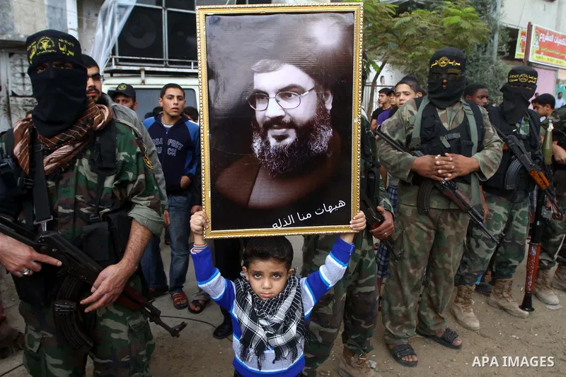Palestinian Islamic Jihad militants and supporters take part in a rally marking the 16th anniversary of the killing of Fathi al-Shiqaqi, the militant movement's founder, in the northern Gaza Strip November 4, 2011. The m...