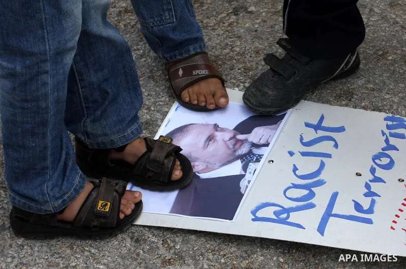 Palestinian demonstrators from the village of Kfar Kadum rally on November 4, 2011 in the Israeli-occupied West Bank as they hold pictures of Palestinian president Mahmud Abbas and Israeli Foreign Minister Avigdor Liberm...