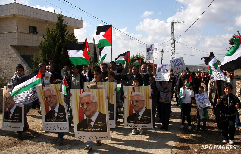 Palestinian demonstrators from the village of Kfar Kadum rally on November 4, 2011 in the Israeli-occupied West Bank as they hold pictures of Palestinian president Mahmud Abbas and Israeli Foreign Minister Avigdor Liberm...